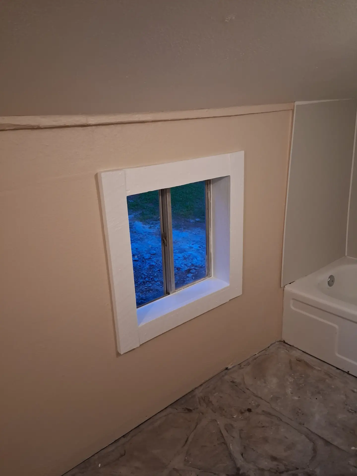 Bathroom window trim installed during a remodeling project